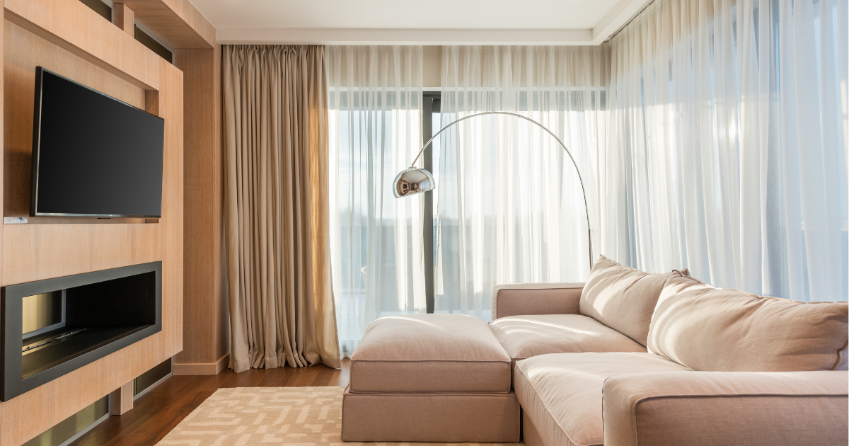 Motorised blinds in a modern NZ living room controlling light and privacy