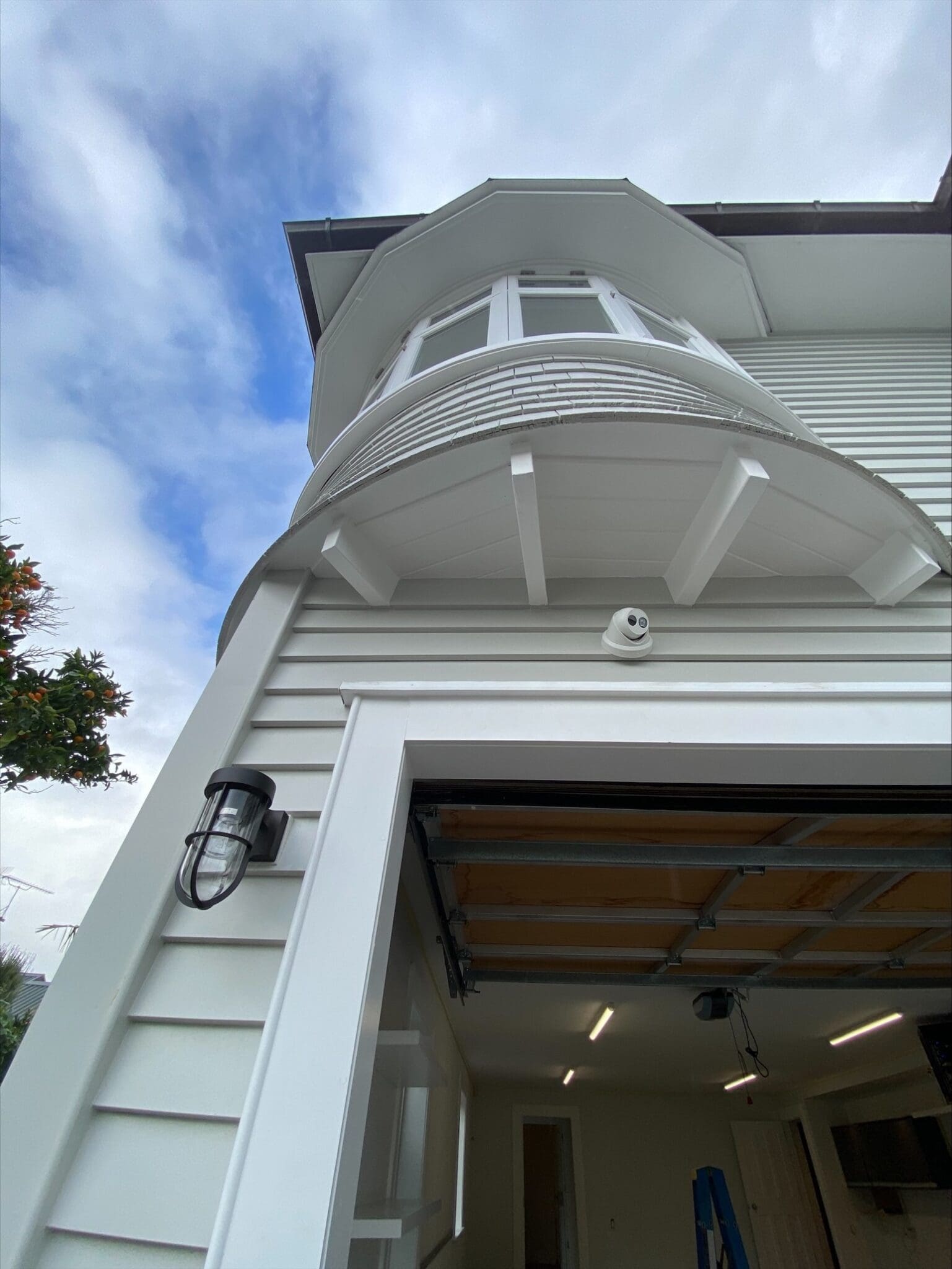 White security camera installed outside a house, for everyday survellaince