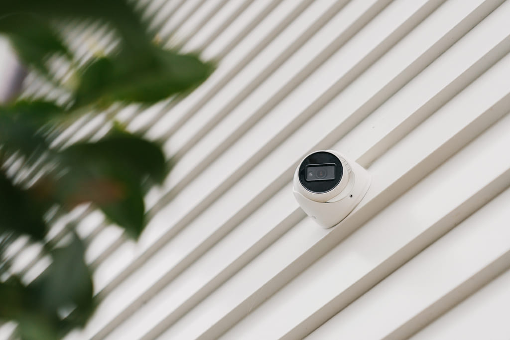 White security camera installed outside a house