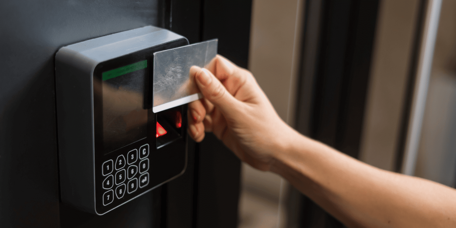 Employee using an access card and keypad at a commercial entry door