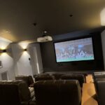 Indoor home theatre with built-in speakers, large screen and integrated smart home audio system