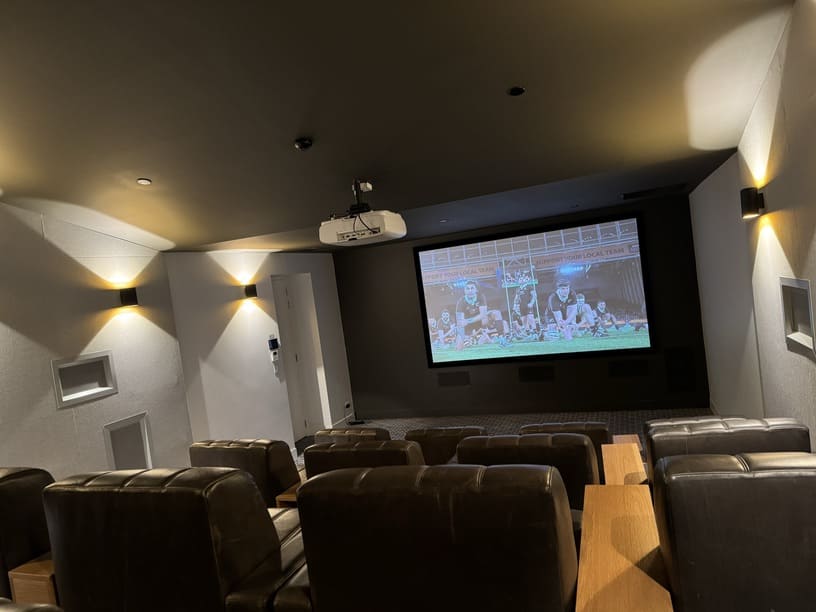 Indoor home theatre with built-in speakers, large screen and integrated smart home audio system